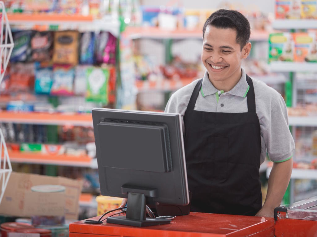 Smiling Business Owner Looking at Monitor